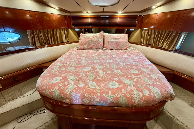  Yacht Photos Pics Luxurious cabin interior of 2000 Fairline Squadron 56 yacht with elegant bedding.