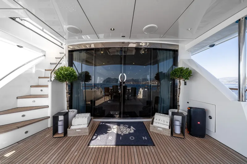 Arion Yacht Photos Pics Luxurious 2011 Guy Couach 121' yacht deck with elegant decor and ocean view.