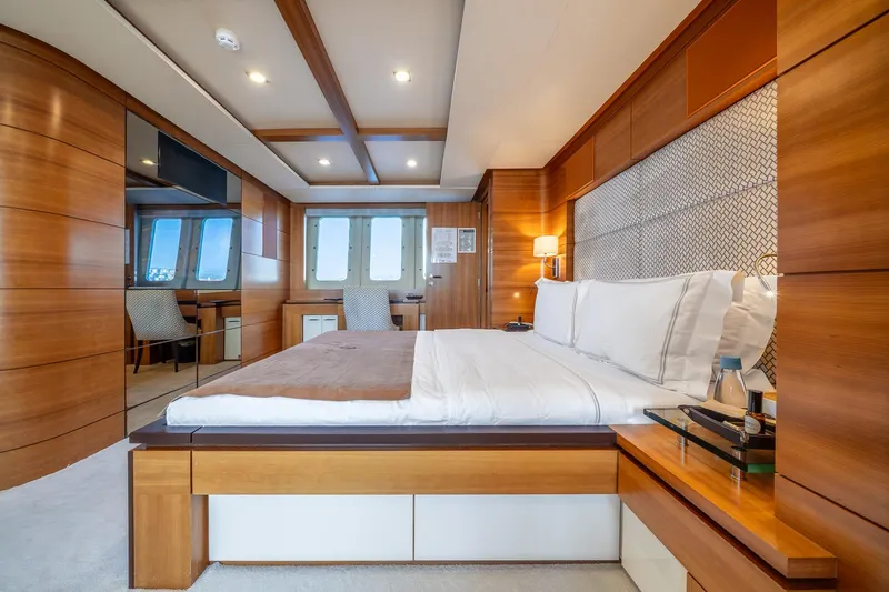 Arion Yacht Photos Pics Luxurious bedroom interior on 2011 Guy Couach 121' yacht with elegant wood paneling.
