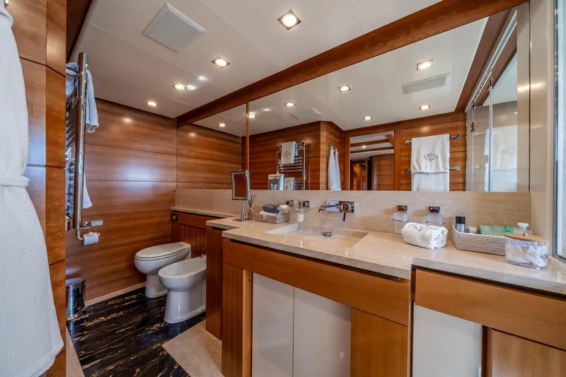Arion Yacht Photos Pics Luxurious bathroom on 2011 Guy Couach 121' yacht, featuring elegant wood paneling and modern fixtures.