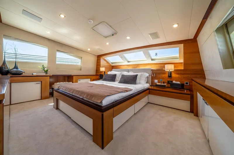 Arion Yacht Photos Pics Luxurious bedroom interior on 2011 Guy Couach 121' yacht, featuring elegant wood finishes and modern design.