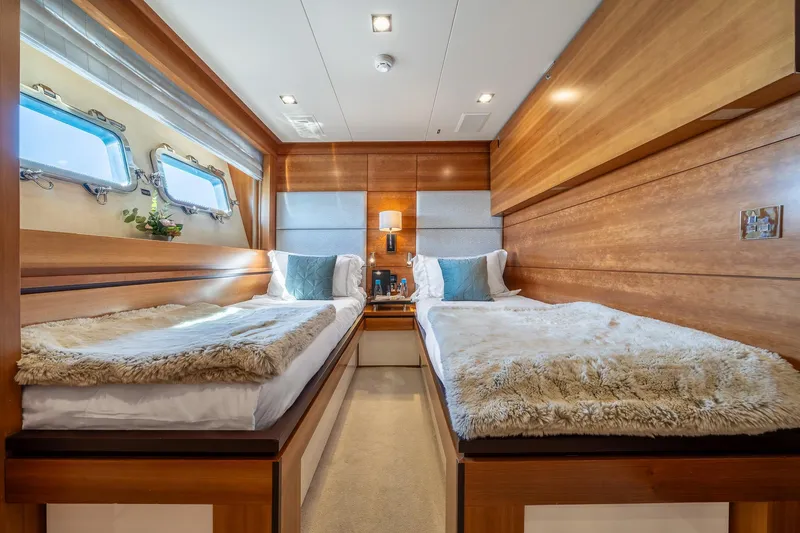 Arion Yacht Photos Pics Luxurious twin cabin interior on 2011 Guy Couach 121' yacht, featuring elegant wood paneling.
