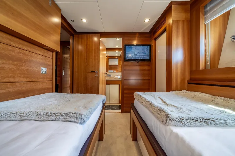 Arion Yacht Photos Pics Luxurious twin cabin interior on 2011 Guy Couach 121' yacht, featuring wood paneling and modern amenities.