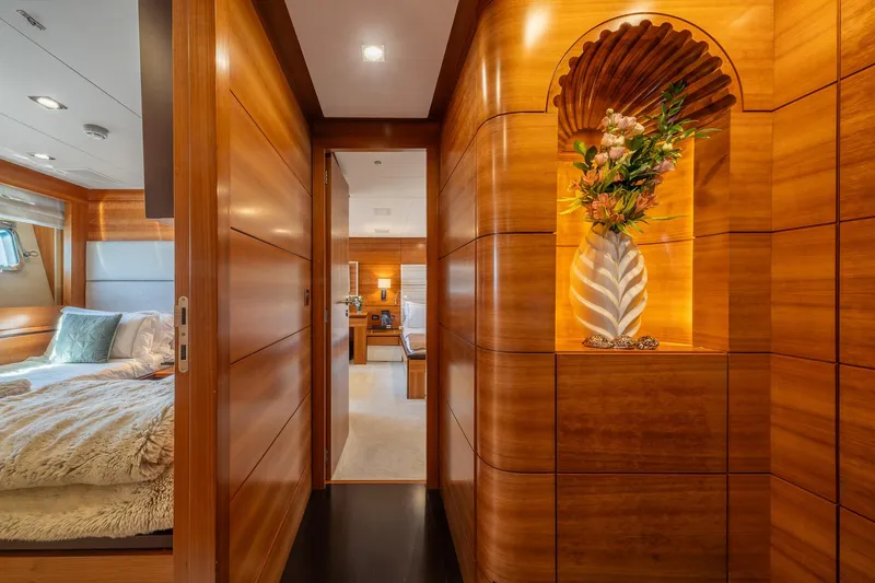 Arion Yacht Photos Pics Luxurious interior of 2011 Guy Couach 121' yacht with elegant wood paneling and floral decor.
