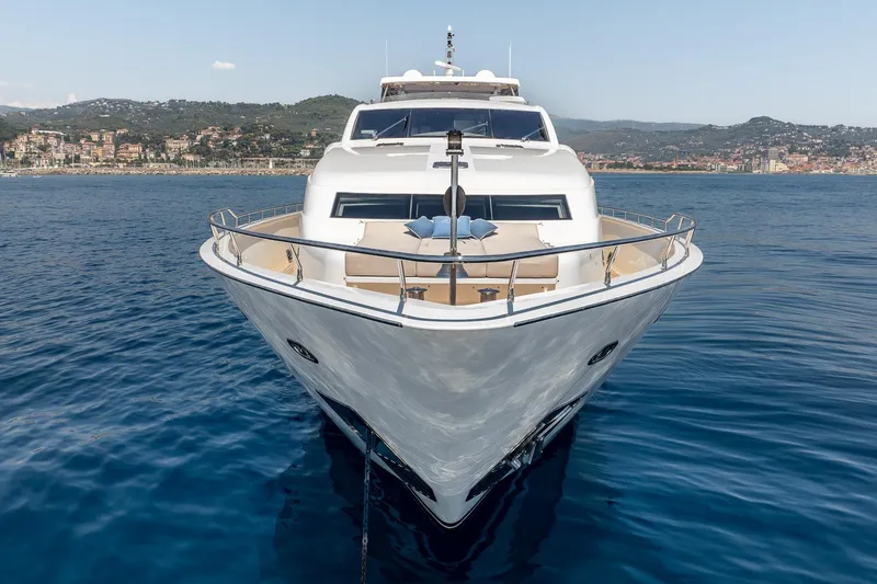 Arion Yacht Photos Pics Luxurious 2011 Guy Couach 121' yacht on serene blue waters near a coastal town.