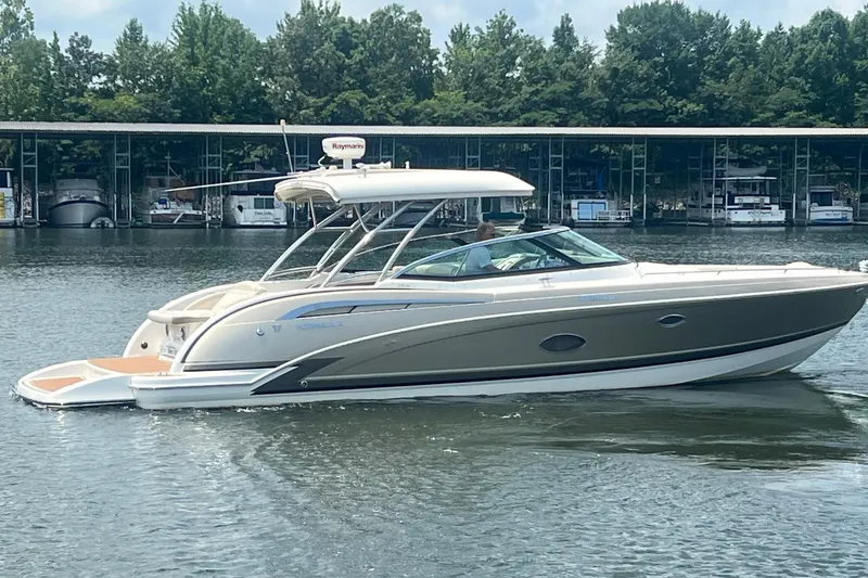 New Trade-in- All Offers & Trades Welcome Yacht Photos Pics 2014 Formula 350 Crossover Bowrider on a calm lake near a marina.