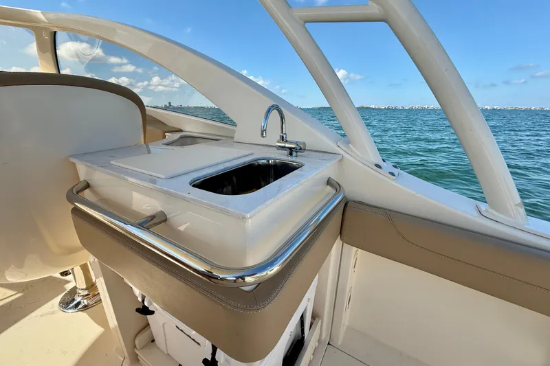  Yacht Photos Pics 2024 Scout 240 Dorado boat interior with sink, overlooking ocean view.