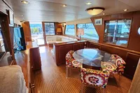 Luxurious 1984 De Groot yacht interior with elegant wood finishes and vibrant seating.
