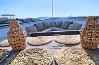 Wicker table setting on De Groot UNIQUE MODEL yacht, 1984, with harbor view.