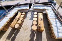 Spacious deck of 1984 De Groot UNIQUE MODEL yacht with wooden seating and tables.