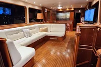 Luxurious 1984 De Groot yacht interior with elegant wood finishes and plush seating.