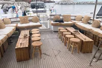 Spacious deck of 1984 De Groot UNIQUE MODEL yacht with wooden seating and tables.