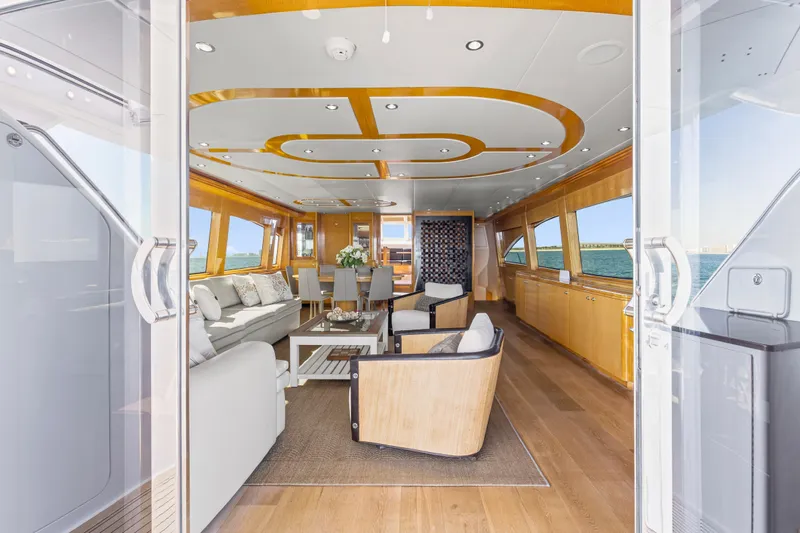 Time-2 Fly Yacht Photos Pics Luxurious interior of 2006 Hatteras 80 Motor Yacht Sky Lounge with elegant seating and ocean view.