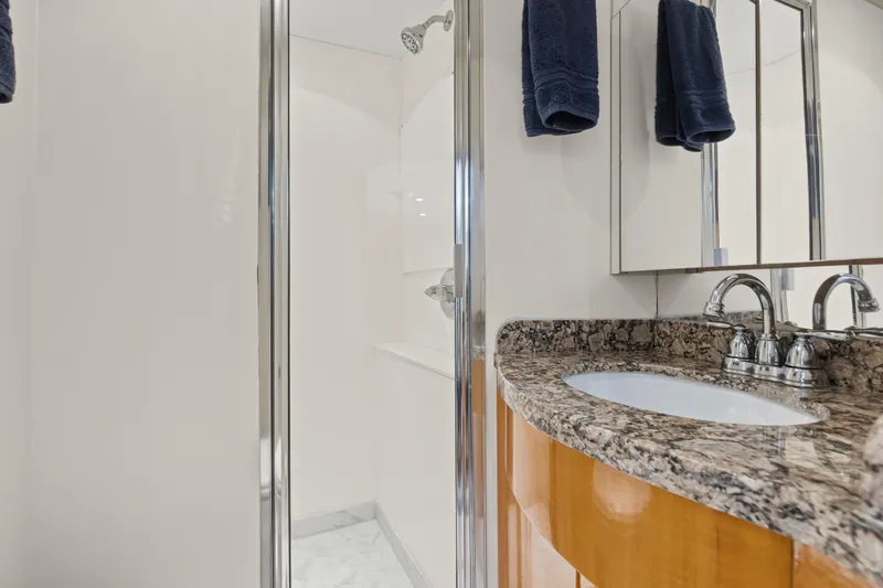 Time-2 Fly Yacht Photos Pics Luxurious bathroom in 2006 Hatteras 80 Motor Yacht Sky Lounge with granite countertop.