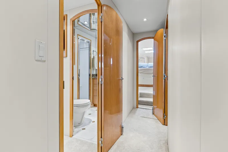 Time-2 Fly Yacht Photos Pics Hallway view inside 2006 Hatteras 80 Motor Yacht Sky Lounge, featuring bathroom and bedroom doors.