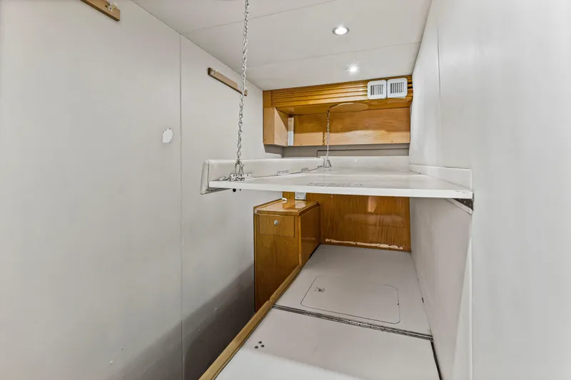 Time-2 Fly Yacht Photos Pics Interior of 2006 Hatteras 80 Motor Yacht Sky Lounge, featuring compact storage space.