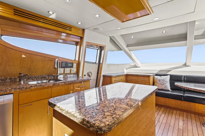 Time-2 Fly Yacht Photos Pics Luxurious interior of 2006 Hatteras 80 Motor Yacht Sky Lounge with granite countertops and seating area.