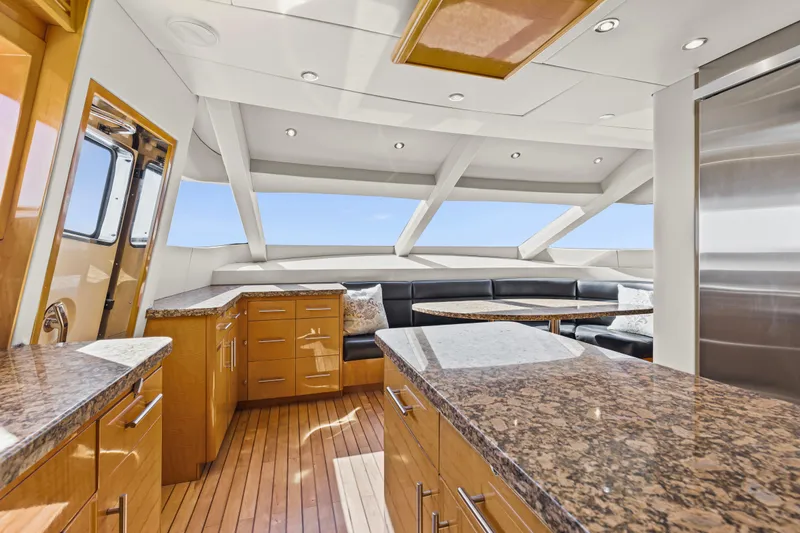 Time-2 Fly Yacht Photos Pics Luxurious interior of 2006 Hatteras 80 Motor Yacht Sky Lounge with modern kitchen and seating area.