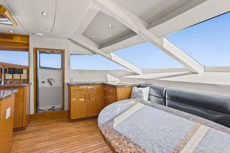 Time-2 Fly Yacht Photos Pics Luxurious interior of 2006 Hatteras 80 Motor Yacht Sky Lounge with sleek design and panoramic windows.