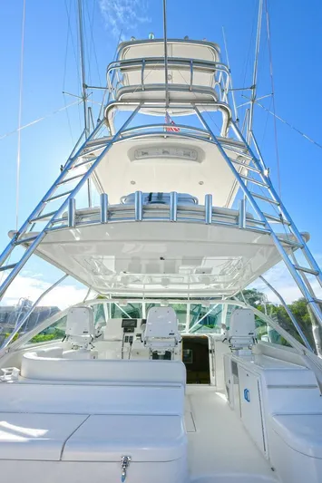 Trios Yacht Photos Pics 2007 Cabo 40 Express with Tower, showcasing sleek design and spacious deck under clear blue sky.