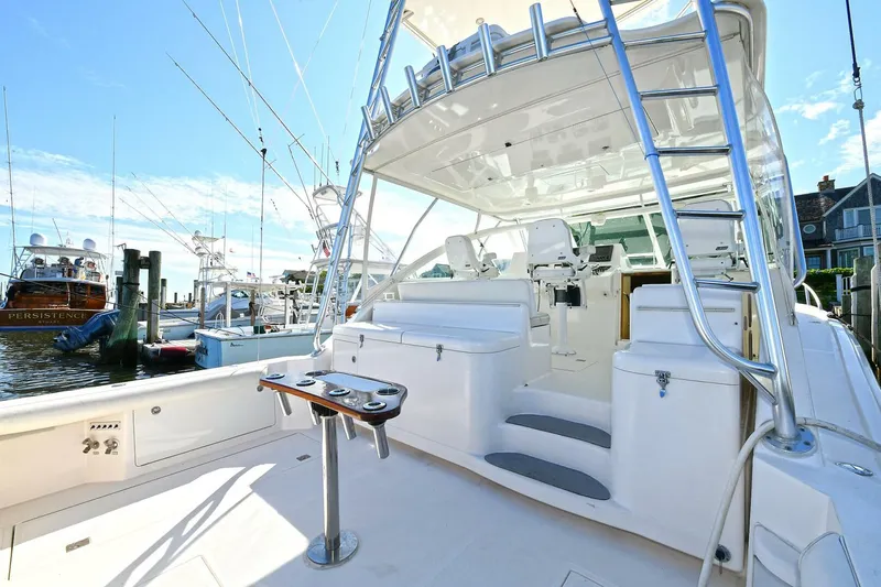 Trios Yacht Photos Pics 2007 Cabo 40 Express with Tower, docked, showcasing spacious deck and fishing equipment.