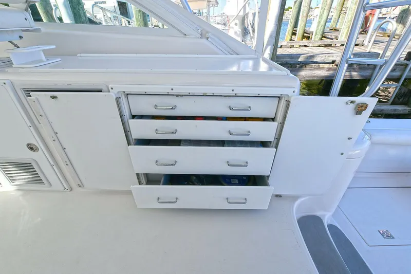 Trios Yacht Photos Pics 2007 Cabo 40 Express boat interior with open storage drawers and cabinets.