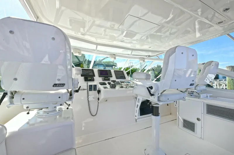 Trios Yacht Photos Pics 2007 Cabo 40 Express helm with tower, featuring dual captain chairs and advanced navigation equipment.