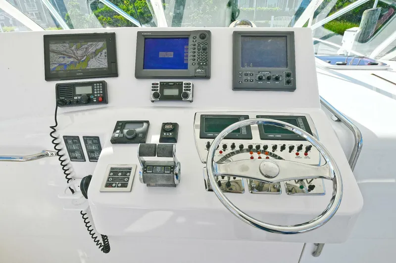 Trios Yacht Photos Pics Control panel of a 2007 Cabo 40 Express with Tower, featuring navigation and communication equipment.