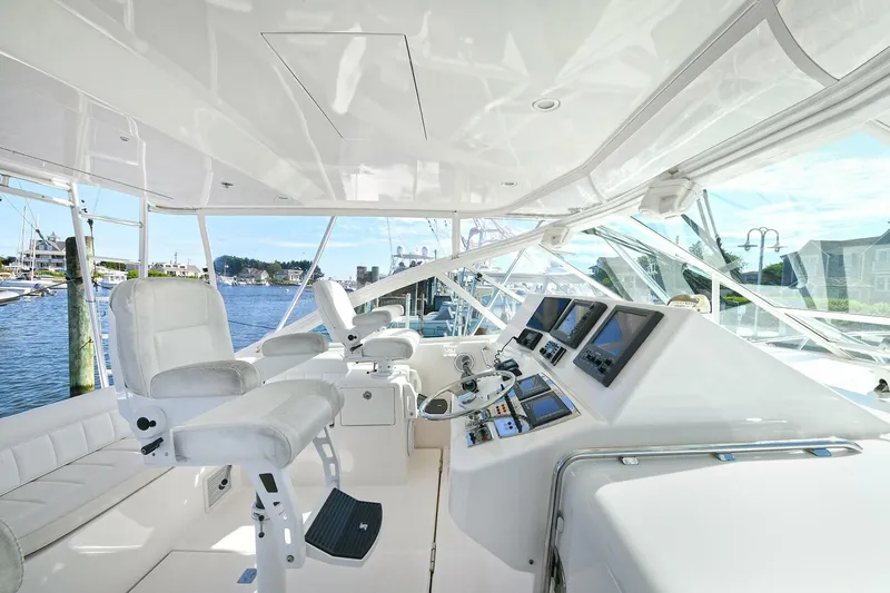 Trios Yacht Photos Pics Luxurious 2007 Cabo 40 Express yacht interior with advanced navigation systems and plush seating.