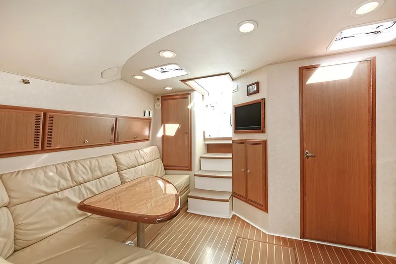 Trios Yacht Photos Pics Luxurious interior of 2007 Cabo 40 Express yacht with leather seating and wooden finishes.