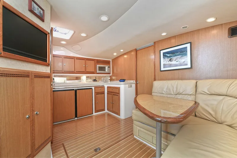 Trios Yacht Photos Pics Luxurious interior of 2007 Cabo 40 Express yacht with wooden cabinetry and leather seating.