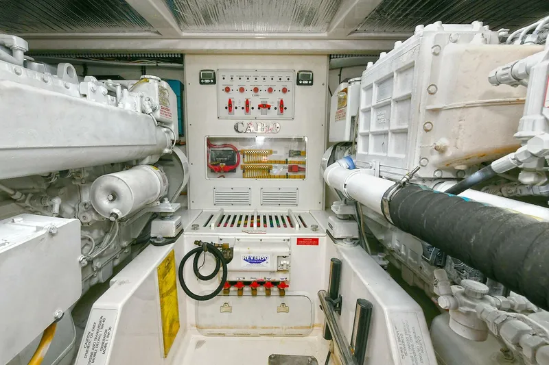 Trios Yacht Photos Pics Engine room of 2007 Cabo 40 Express with Tower, showcasing mechanical components and control panel.