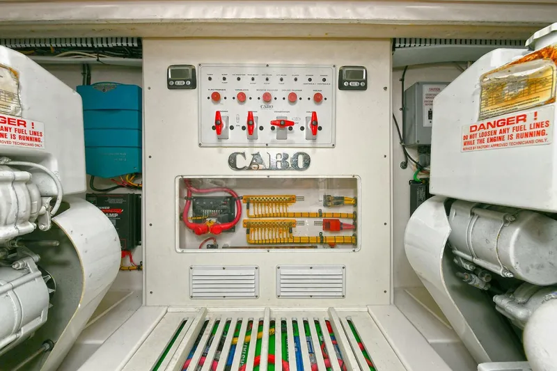 Trios Yacht Photos Pics Engine room of 2007 Cabo 40 Express with Tower, featuring control panel and machinery.