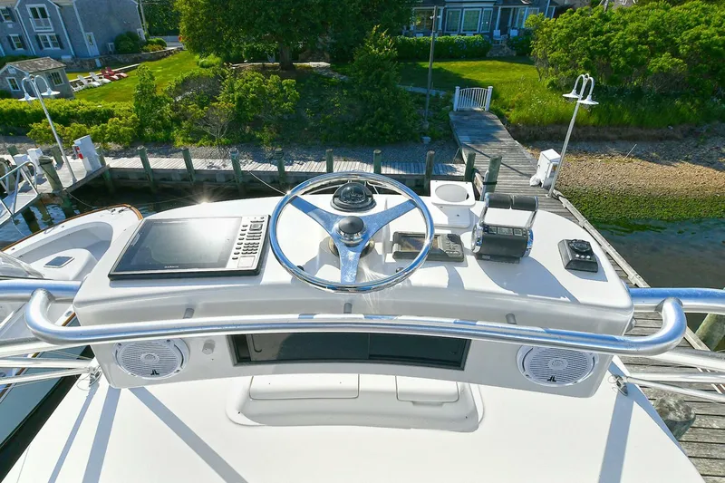 Trios Yacht Photos Pics 2007 Cabo 40 Express boat helm with navigation equipment and scenic dock view.