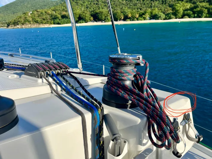 Family Therapy Yacht Photos Pics Fountaine Pajot Elba 45 sailboat deck with ropes, near tropical shoreline, 2023 model.