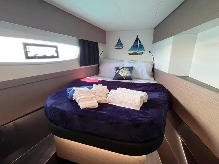 Family Therapy Yacht Photos Pics Luxurious cabin interior of 2023 Fountaine Pajot Elba 45 catamaran with cozy bedding.