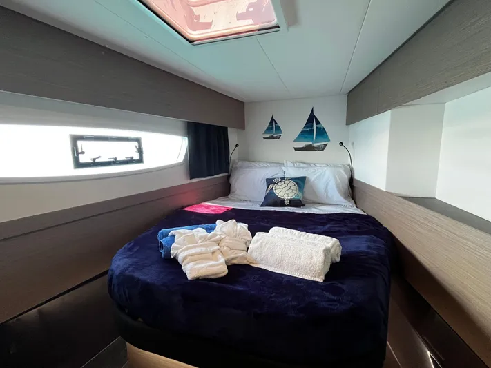 Family Therapy Yacht Photos Pics Luxurious cabin interior of 2023 Fountaine Pajot Elba 45 catamaran with cozy bedding.