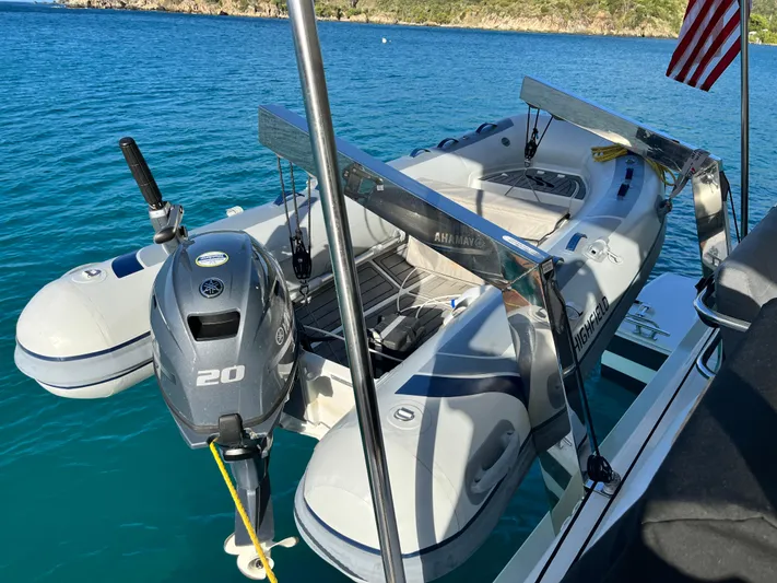 Family Therapy Yacht Photos Pics Inflatable boat with motor on Fountaine Pajot Elba 45, 2023, in clear blue water.