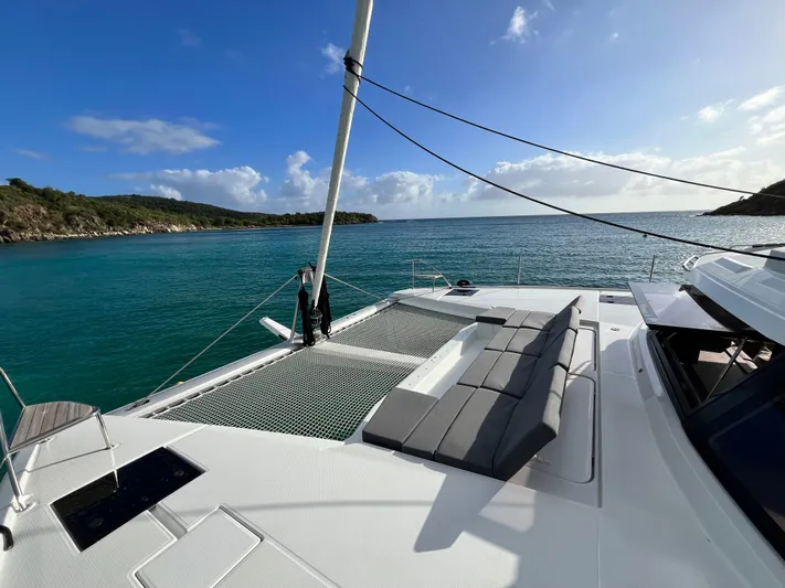 Family Therapy Yacht Photos Pics 2023 Fountaine Pajot Elba 45 catamaran on serene turquoise waters, featuring spacious deck seating.