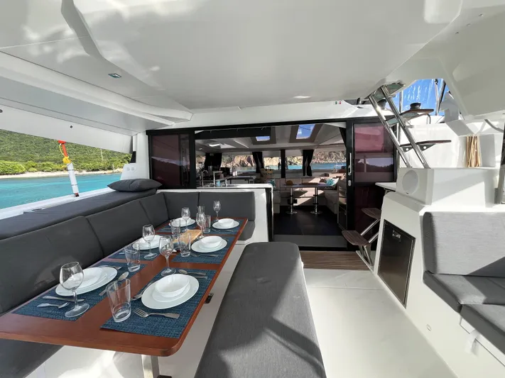 Family Therapy Yacht Photos Pics Luxurious 2023 Fountaine Pajot Elba 45 catamaran interior with elegant dining setup.