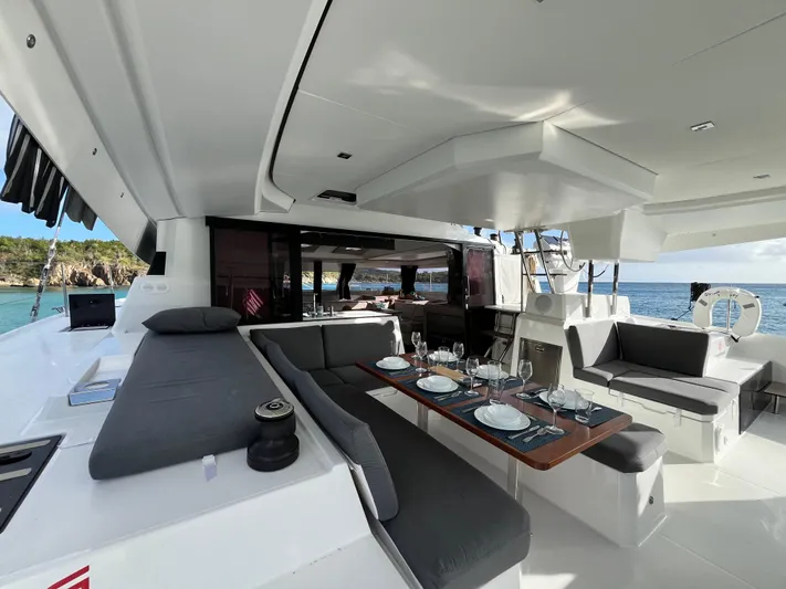 Family Therapy Yacht Photos Pics Luxurious 2023 Fountaine Pajot Elba 45 yacht with elegant outdoor dining area.
