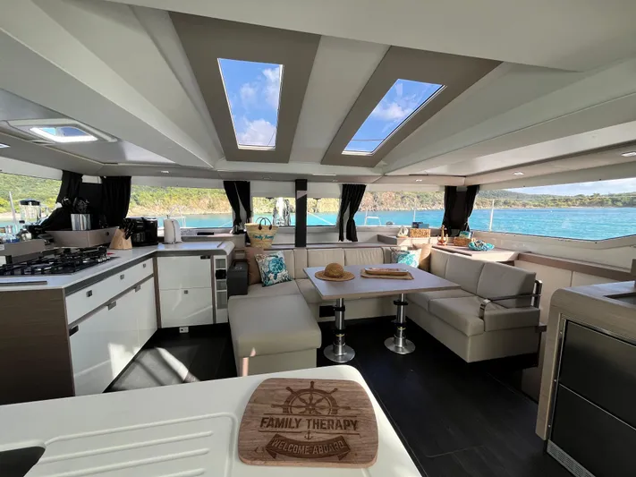 Family Therapy Yacht Photos Pics Luxurious interior of 2023 Fountaine Pajot Elba 45 catamaran with ocean view.