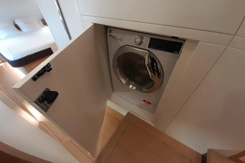  Yacht Photos Pics Built-in washing machine on 2023 Pardo Yachts E60, with open cabinet door.