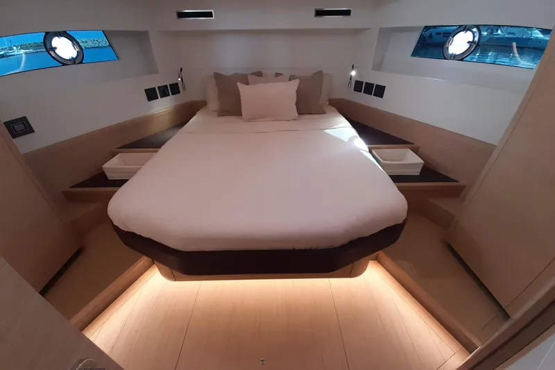  Yacht Photos Pics Luxurious cabin interior of 2023 Pardo Yachts E60 with elegant bedding and ambient lighting.