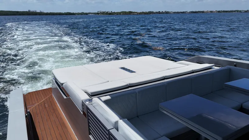  Yacht Photos Pics 2021 De Antonio Yachts D42 cruising on open water, featuring spacious deck seating.
