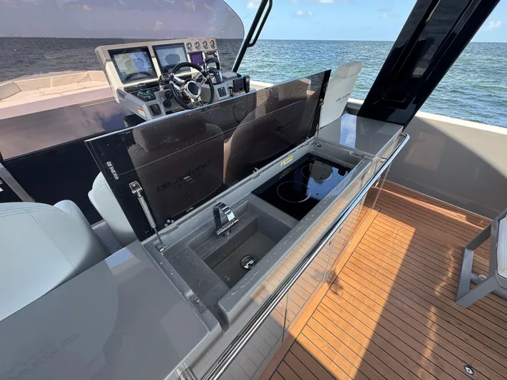  Yacht Photos Pics 2021 De Antonio Yachts D42 helm with modern controls and sleek design on open water.
