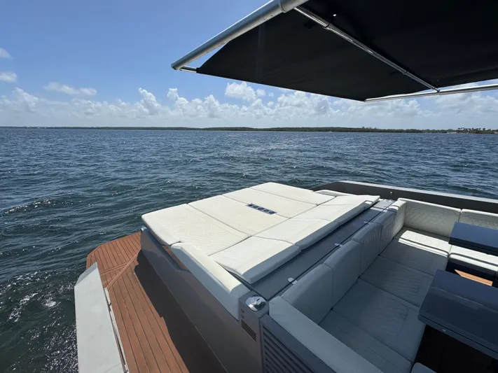  Yacht Photos Pics Luxurious 2021 De Antonio Yachts D42 with sunbed and canopy on open water.