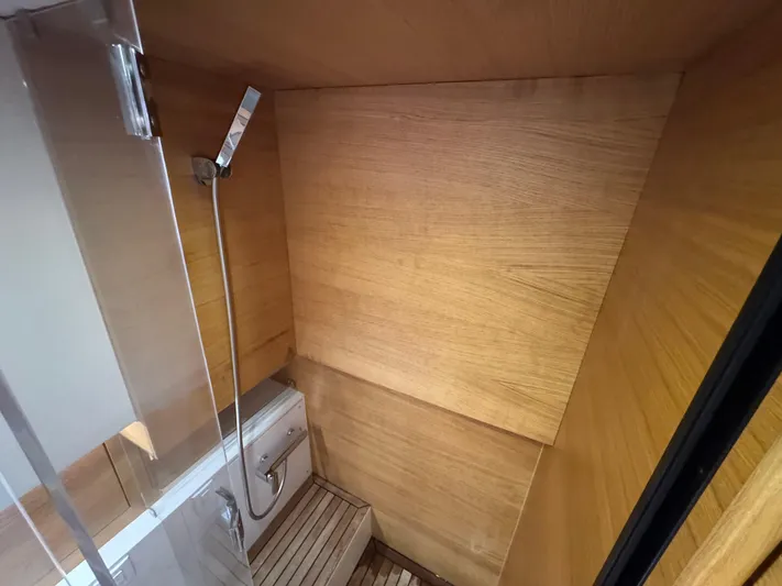  Yacht Photos Pics Luxurious wooden interior of 2021 De Antonio Yachts D42 bathroom with modern fixtures.