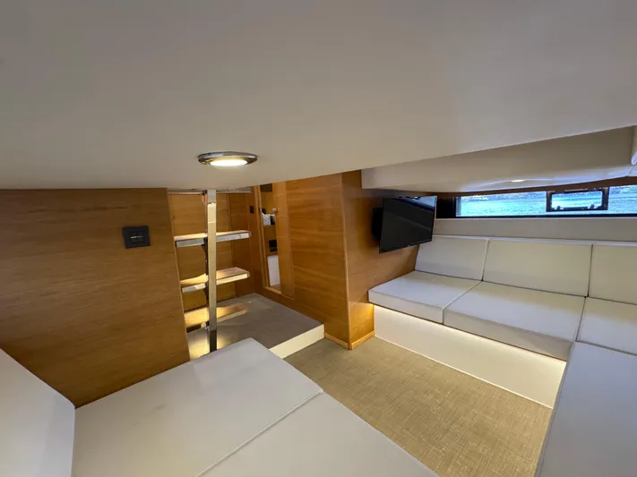  Yacht Photos Pics Interior of 2021 De Antonio Yachts D42, featuring modern seating and wooden accents.