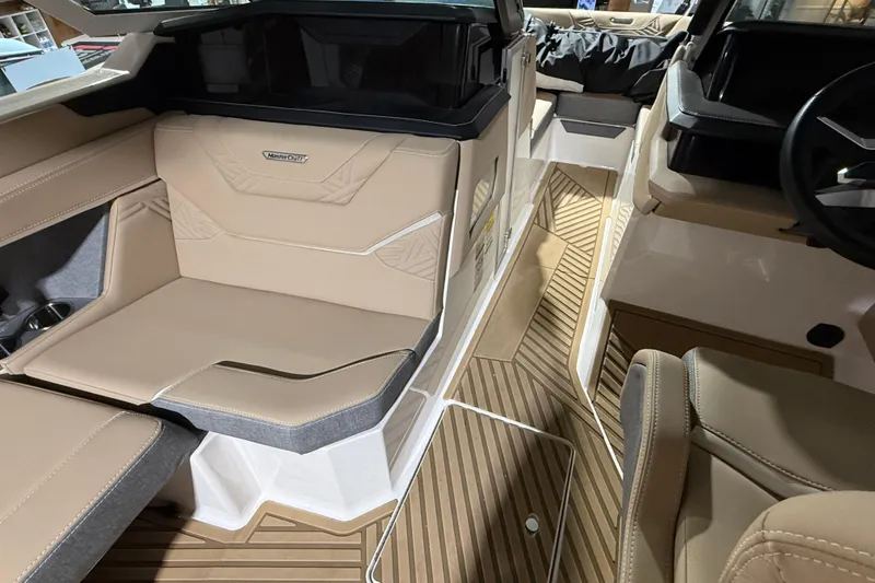  Yacht Photos Pics 2025 MasterCraft XStar 23 interior with beige seating and wood-patterned flooring.